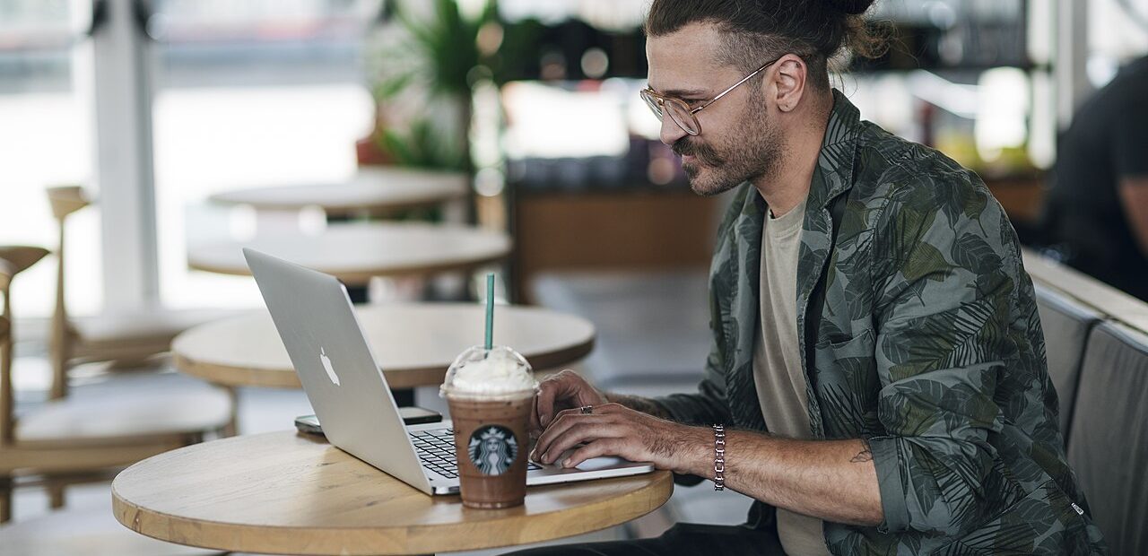 Freelancer working on a laptop in a cafe