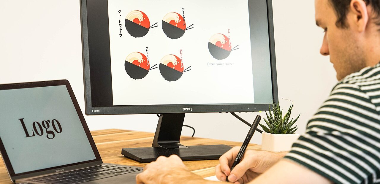 Designer working on a logo with a drawing tablet