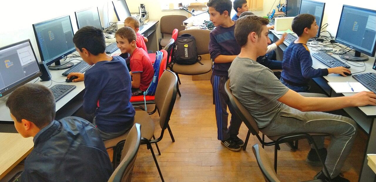 Learners working on computers in a tech lab