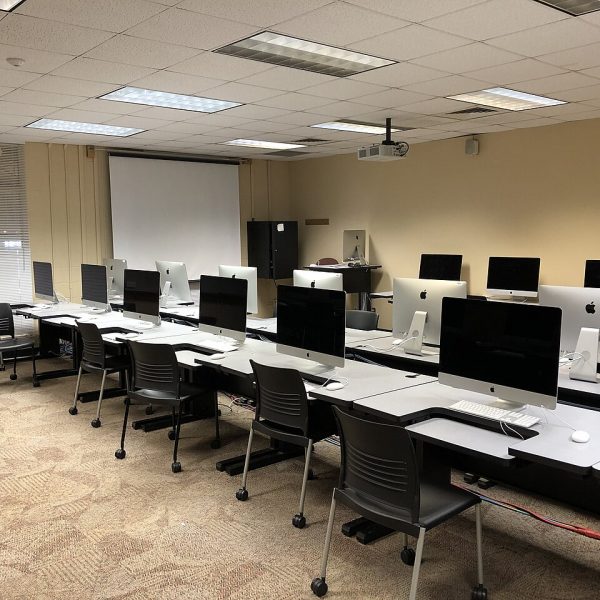 Computer lab with rows of desktop computers